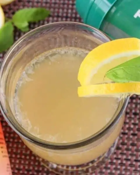 A glass cup of homemade lemon juice.
