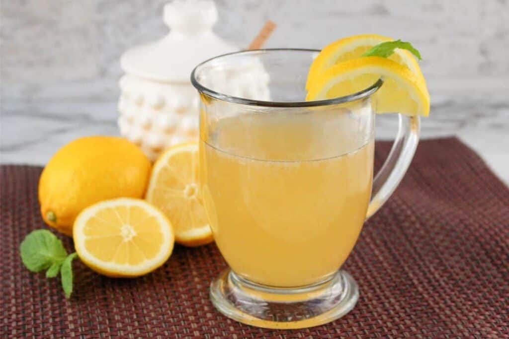 A full glass of copycat Starbucks medicine ball with lemon slices.