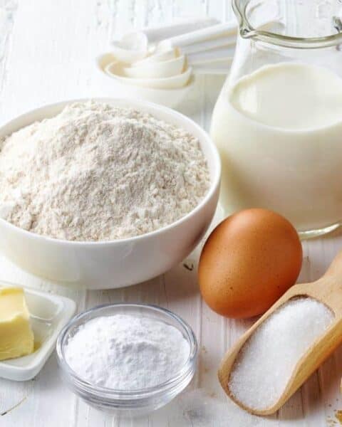 Ingredients and baking supplies needed for saving money including eggs, milk, butter, flour, sugar, and more.