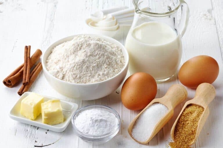 Ingredients and baking supplies needed for saving money including eggs, milk, butter, flour, sugar, and more.