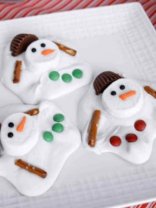Three melted snowman barks on a white square plate.