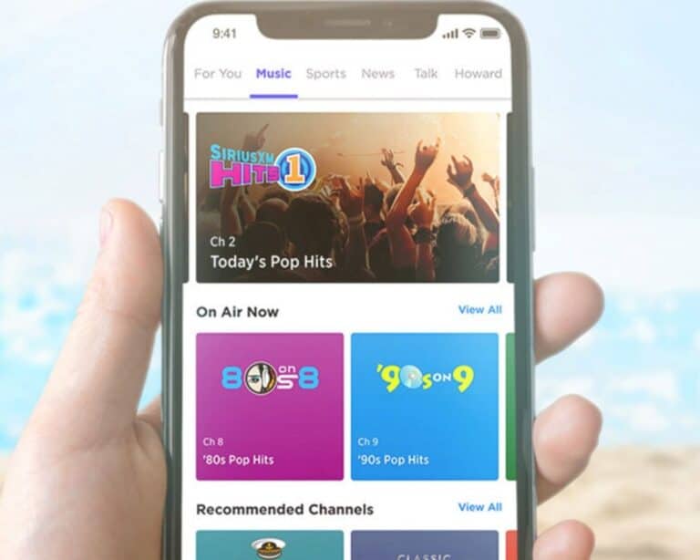 A woman holding a smartphone with the satellite radio app.