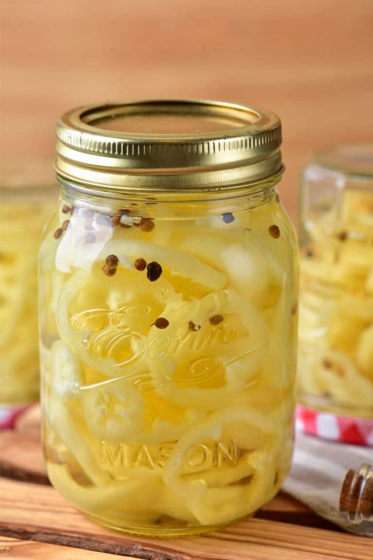 A mason jar with pickled banana peppers.