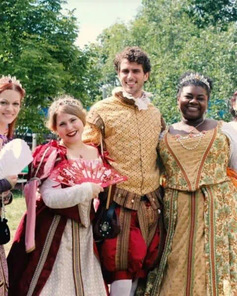 A group of men and women dressed in Renaissance clothing.