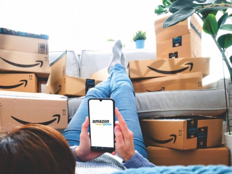 A woman on the Amazon app surrounded by packages and boxes from Amazon.