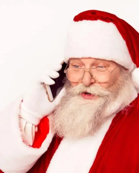 Santa Claus talking on a smartphone.