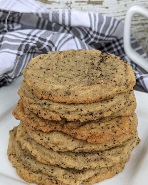 A stack of soft and chewy coffee cookies on a white plate.