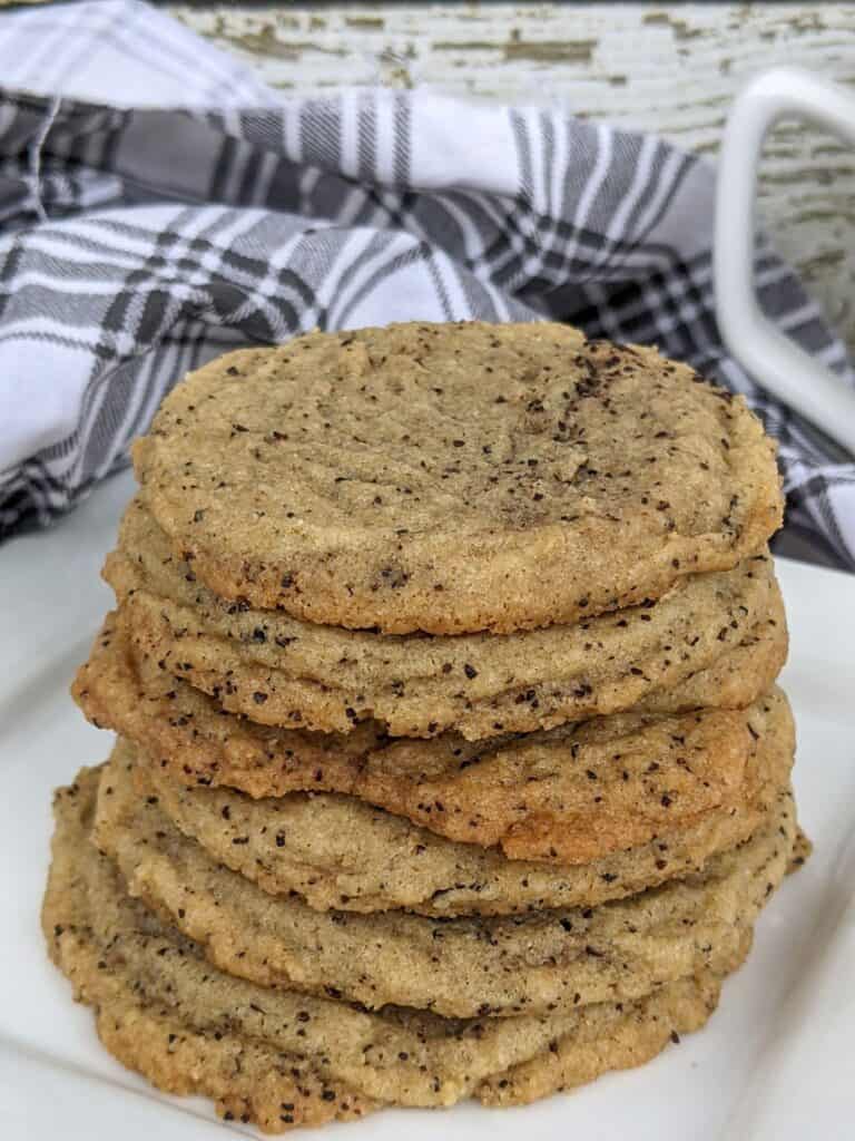A stack of soft and chewy coffee cookies on a white plate.