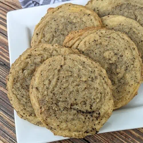 A white square plate of baked soft and chewy coffee cookies.