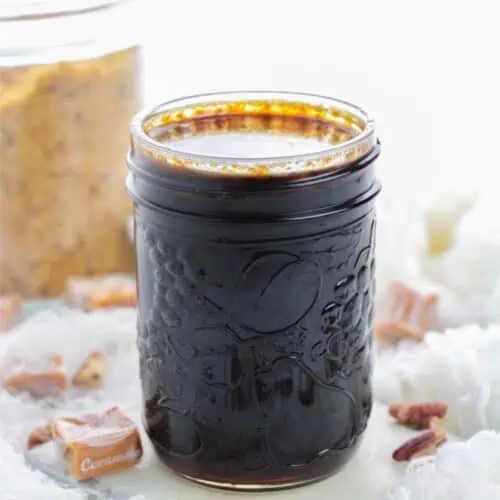 Small mason jar with dark pecan caramel syrup.