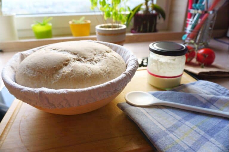 A bowl in a warm spot in the kitchen with a rise of dough.