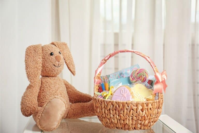 An adorable teddy bear surrounded by Easter basket stuffers.