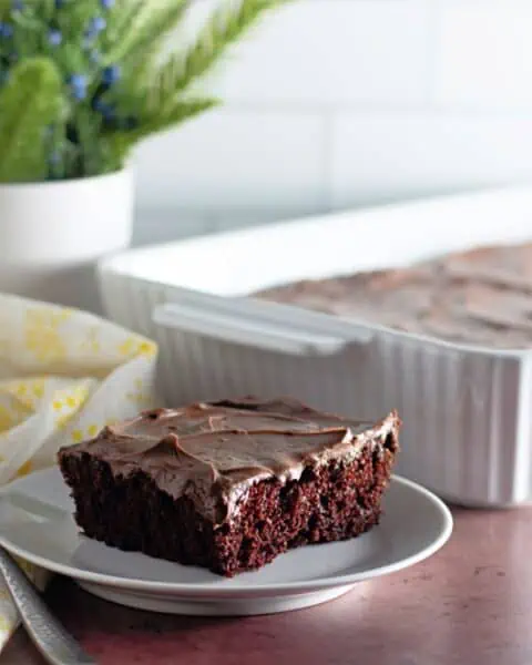 A mouthwatering chocolate cake, prepared with the crazy cake recipe, served on a plate with a fork.
