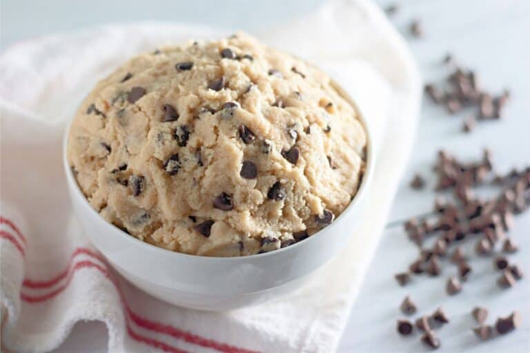 Edible chocolate chip cookie dough displayed in a white bowl.