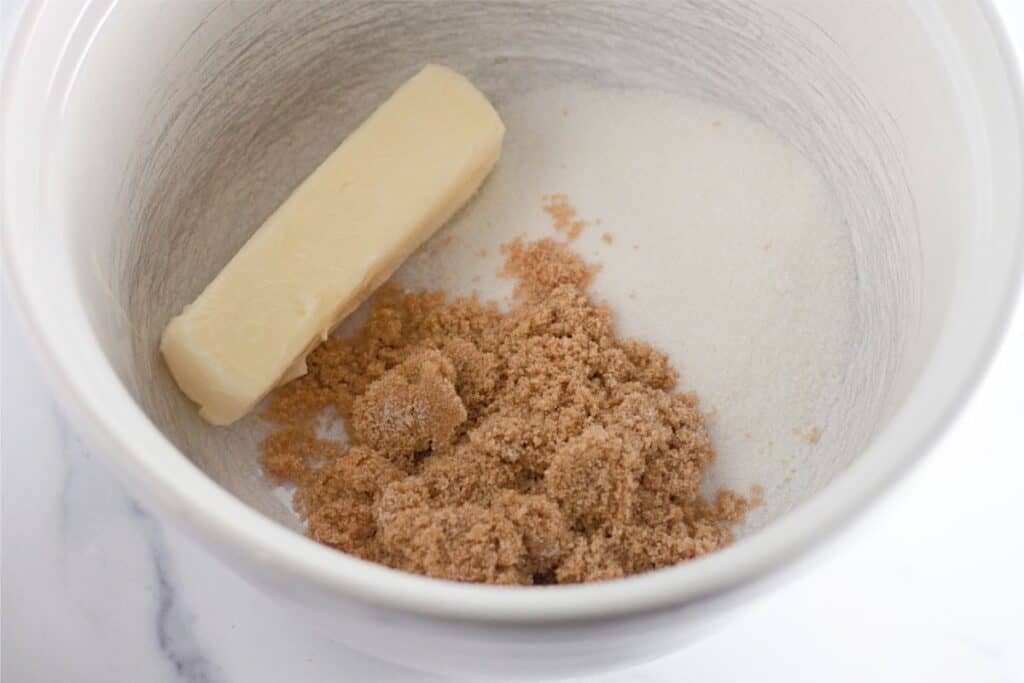 Edible cookie dough made with butter and sugar in a white bowl.