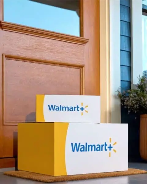 Two Walmart boxes sit on the steps of a house.