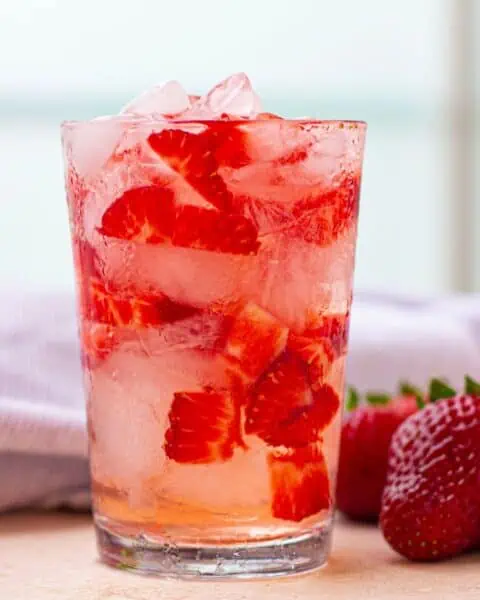 A refreshing Starbucks beverage with strawberries and ice.