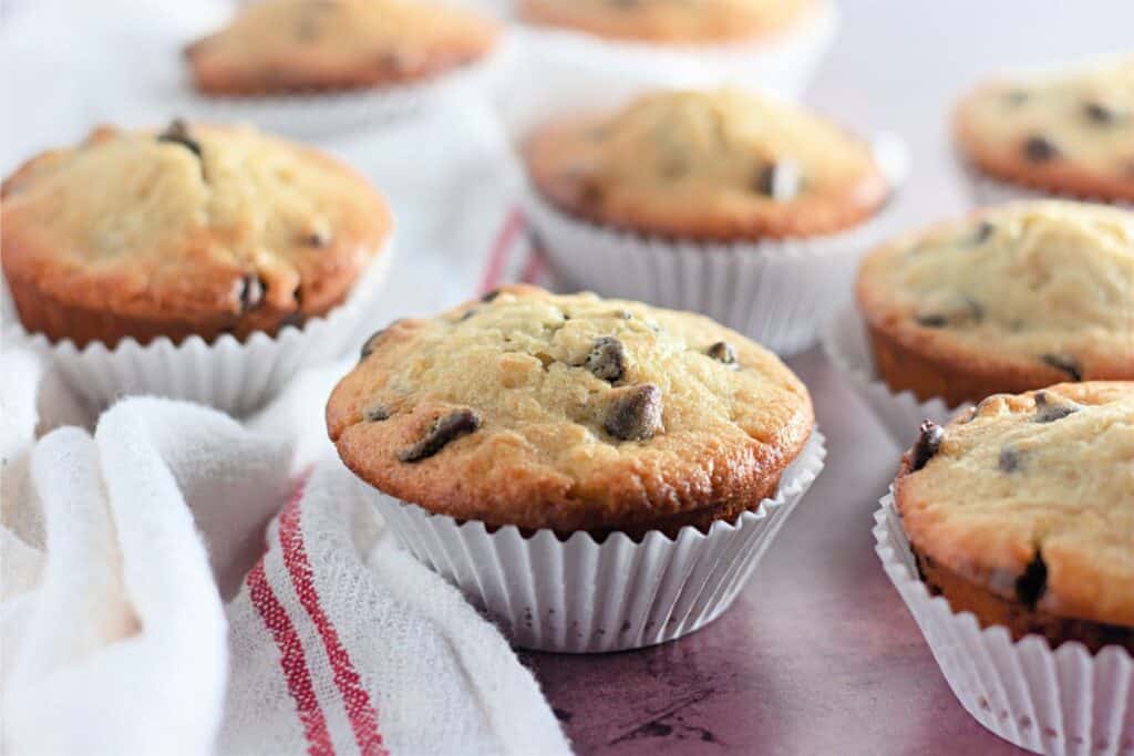 Banana chocolate chip muffins on a napkin.