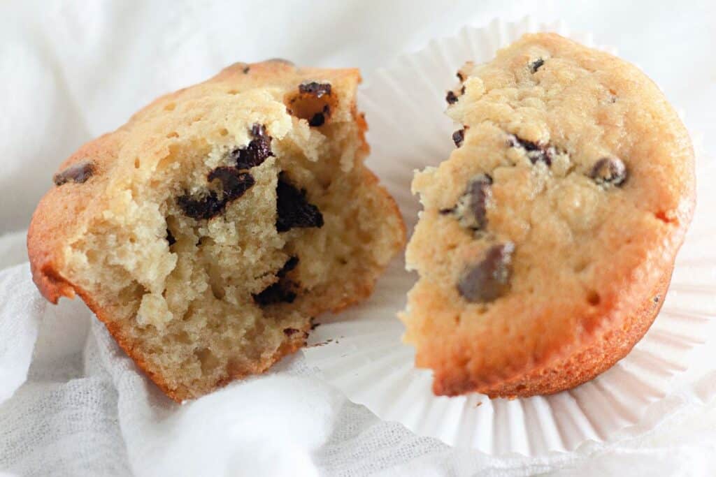 Banana chocolate chip muffins on a white napkin.