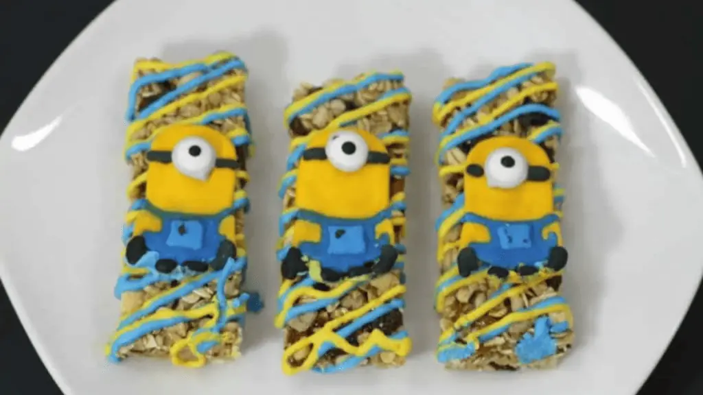 a plate of granola bars with minion decoration.