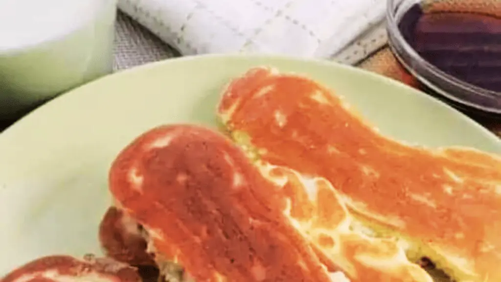 bacon in pancakes on a plate.