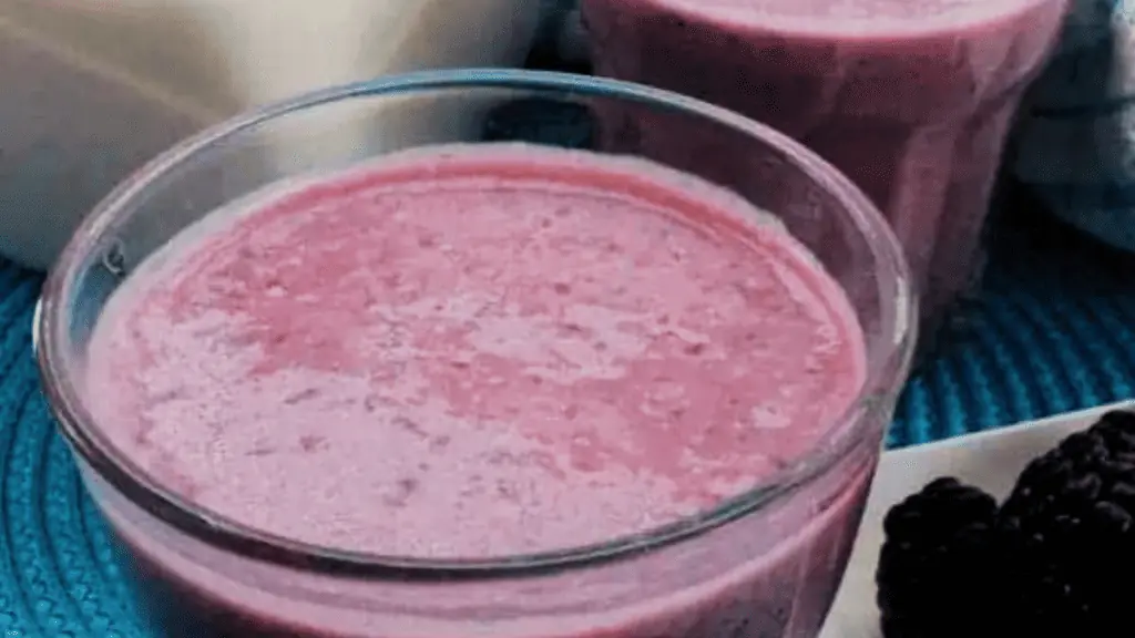 A glass of blueberry pomegranate smoothie.