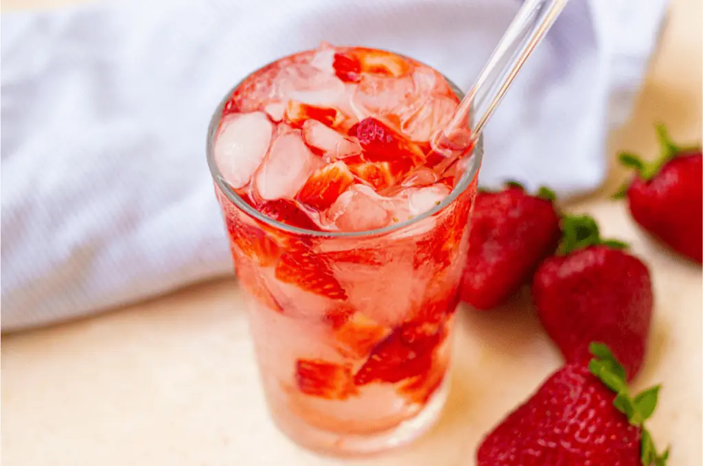 A refreshing Starbucks Strawberry Acai Refresher with strawberries.