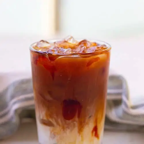 A Starbucks Iced Caramel Macchiato on a table.