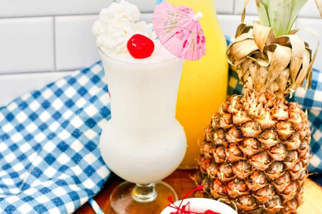 A virgin Pina Colada milkshake topped with whipped cream and a cherry.