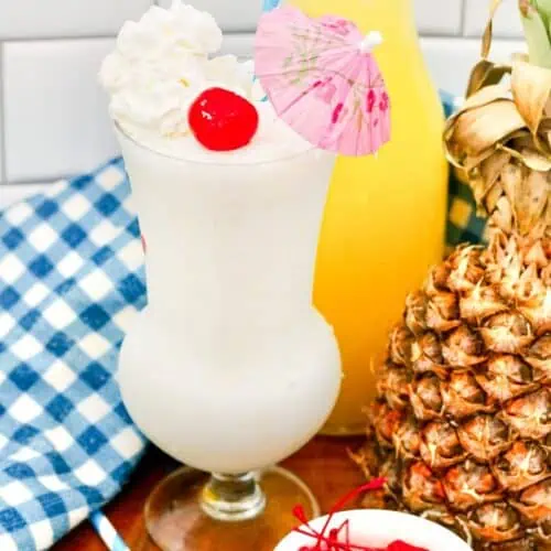 A virgin Pina Colada milkshake topped with whipped cream and a cherry.