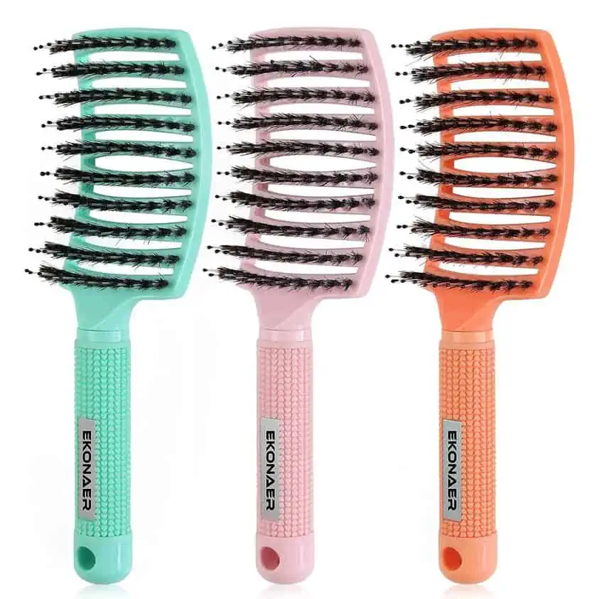 Three different colored hair brushes on a white background, available for October 20th Deals.