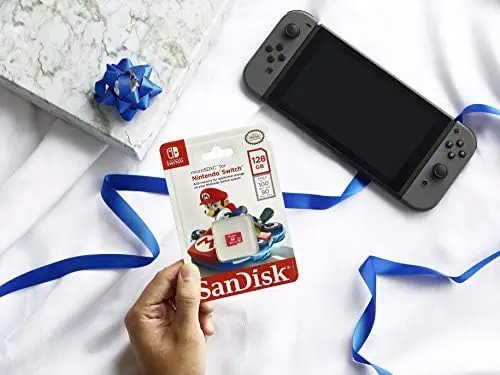 A person holding a Nintendo Switch during the October 27th Deals, with a Sandisk card inserted.
