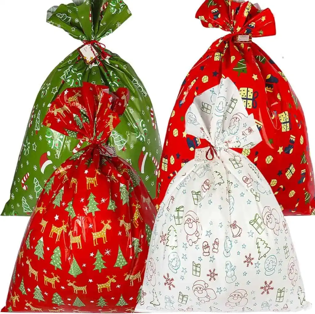 Four christmas gift bags with christmas decorations on them, now available at discounted prices as part of the October 13th Deals.