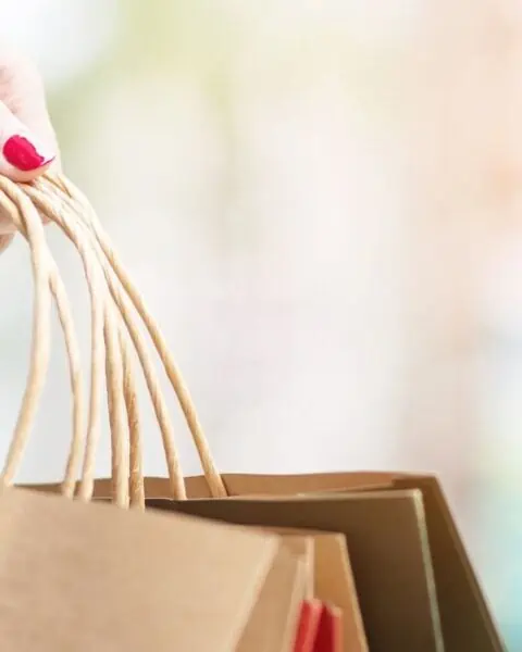 A woman holding shopping bags during October 10th Deals.