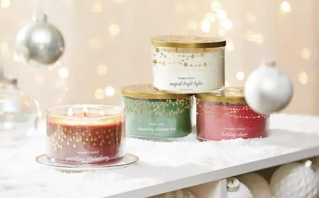 Three candle jars adorned with Christmas ornaments available at great November 25th deals.