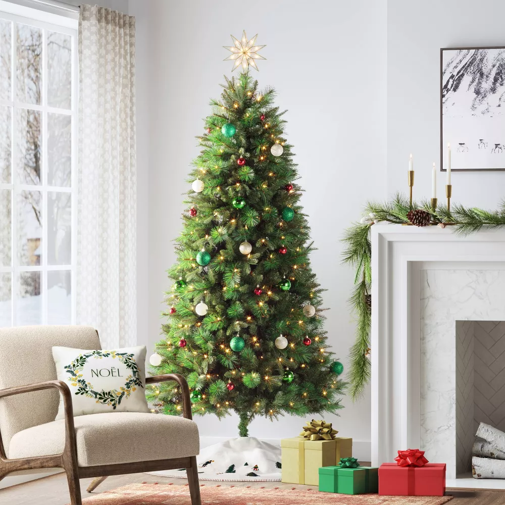 A living room with a Christmas tree and festive decorations for November 24th deals.