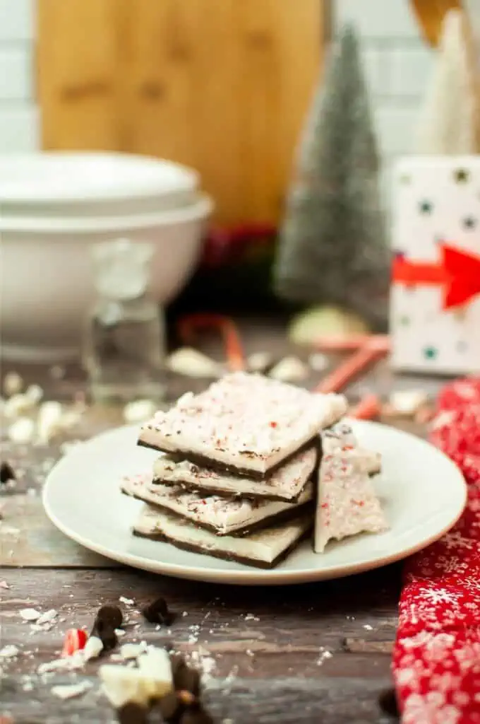 Peppermint bark displayed beside a Christmas tree.