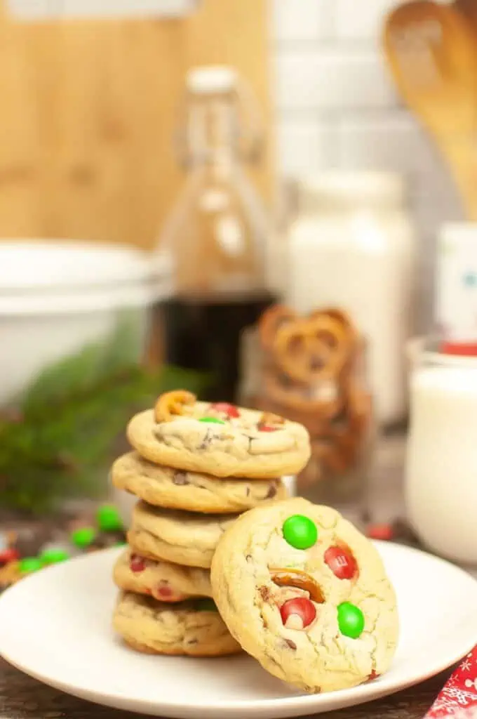 A plate of m&m cookies decorated with candy canes.