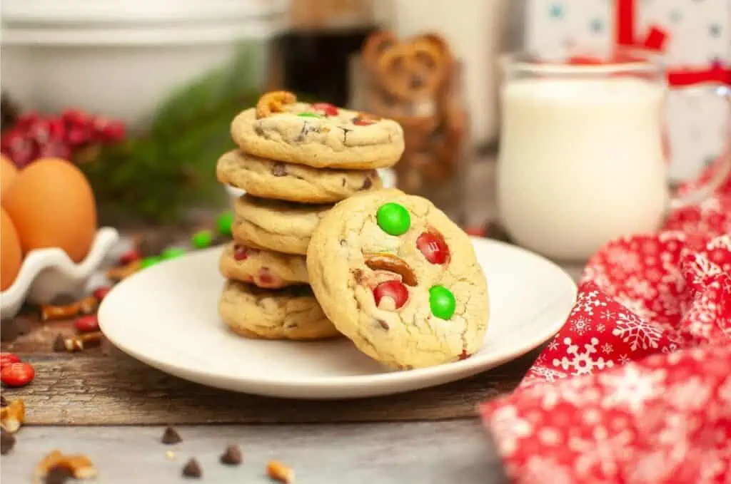 A stack of Christmas cookies, featuring a delightful M&M cookie recipe, arranged tastefully on a plate.