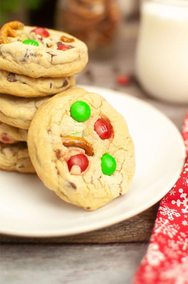 A stack of Christmas cookies on a plate, featuring an irresistible m&m cookie recipe.