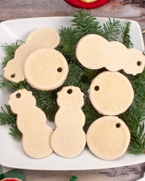 A plate of Salt Dough christmas ornaments on a table.