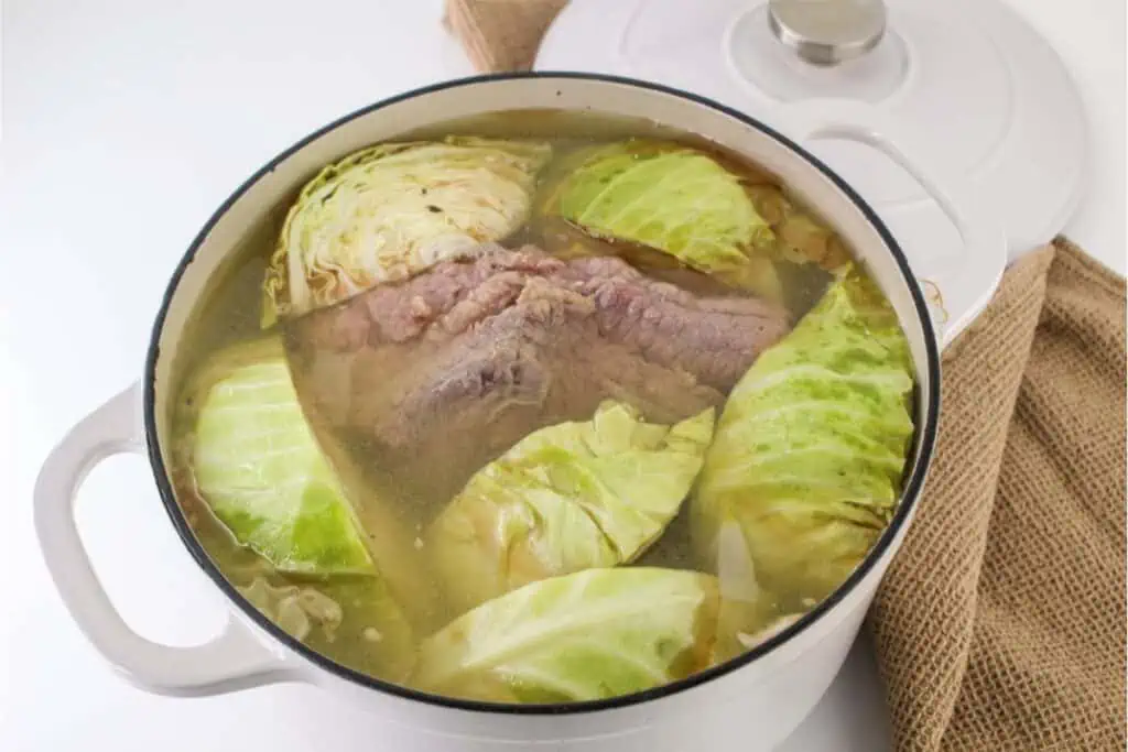 A Dutch Oven filled with succulent corned beef and cabbage.