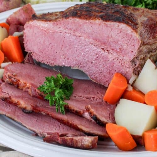 A flavorful plate of corned beef with tender carrots and perfectly cooked potatoes.