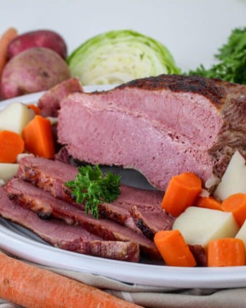 A plate of corned beef and cabbage, cooked in a Dutch Oven.