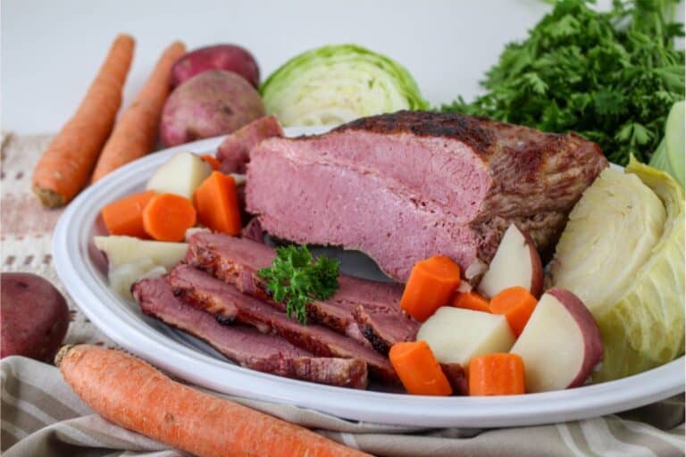 A plate of corned beef and cabbage, cooked in a Dutch Oven.