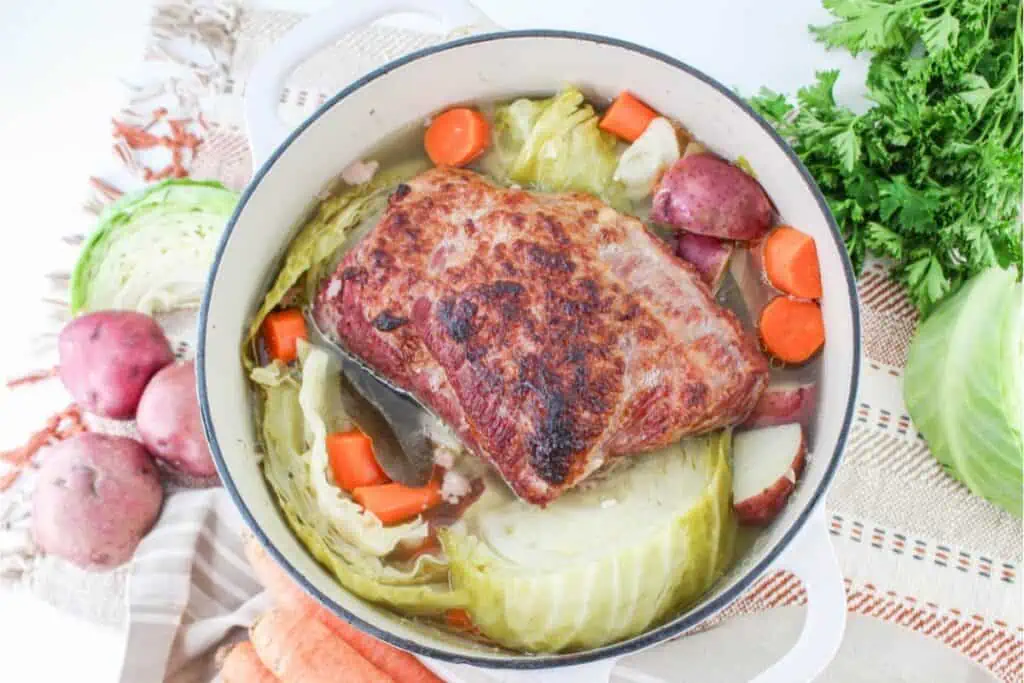 A Dutch oven pot with corned beef and cabbage.