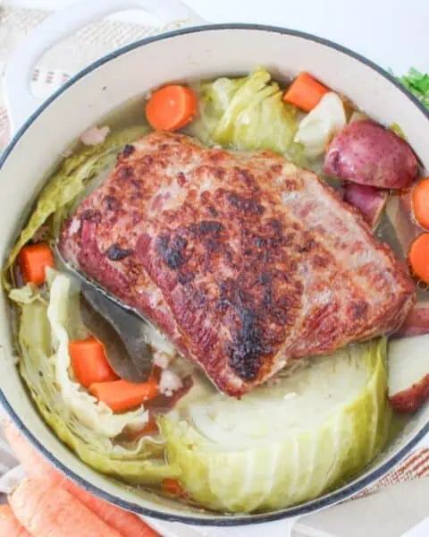 A Dutch oven pot with corned beef and cabbage.
