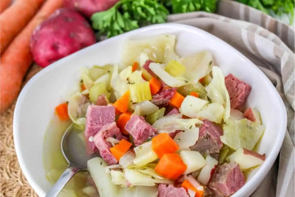A corned beef and cabbage soup recipe with carrots and potatoes.