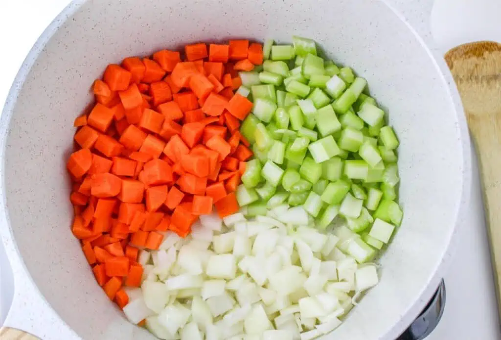 Chopped carrots and celery in a pan for Cabbage Soup.