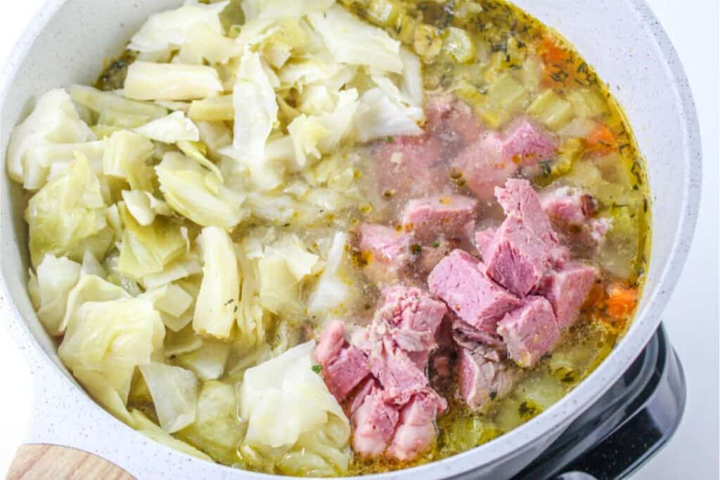 Corned beef and cabbage soup in a pot.